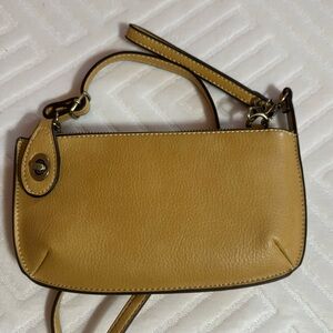 Joy Susan purse. Fits cell phone. Has credit card section and locking latch.